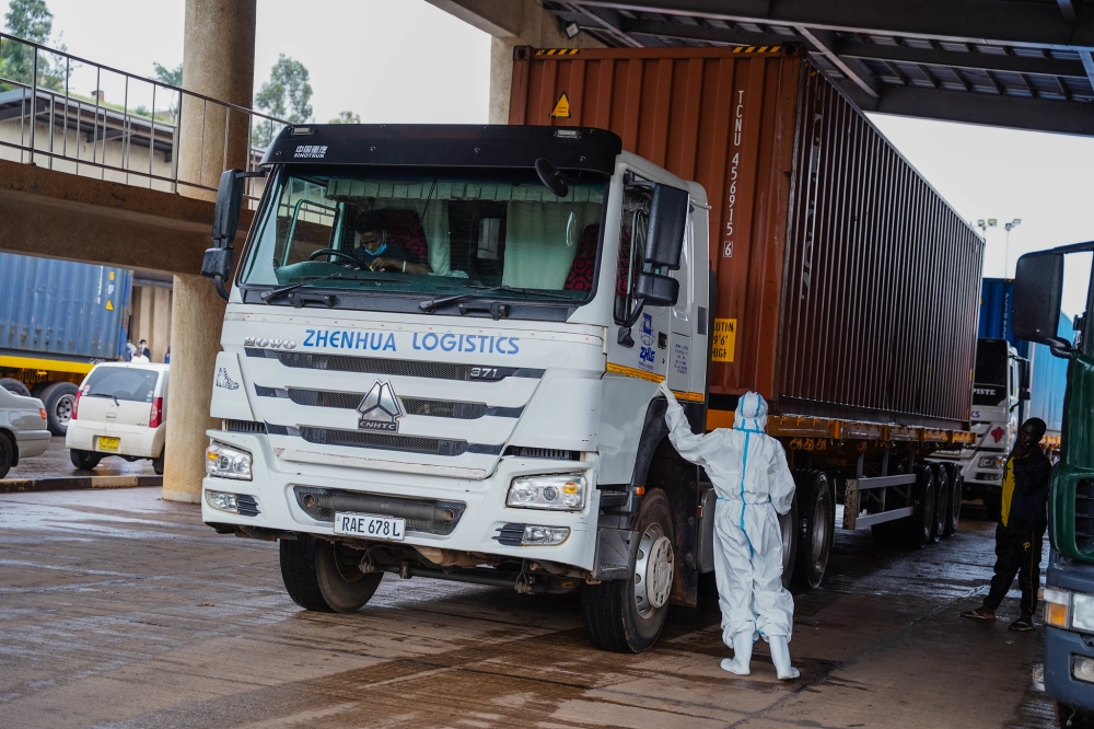 Health worker inspects a cross border truck at Rusumo One Stop Border Post, during the Covid 19 period. Craish Bahizi