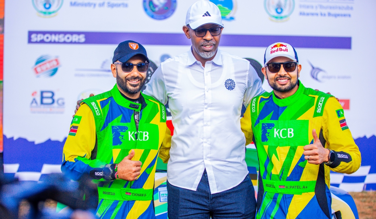 Minister of Sports Richard Nyirishema poses for a photo with Kenyan driver Karan Patel and his co-driver Tauseef Khan as they retained the Rwanda Mountain Gorilla Rally title on Sunday. Courtesy