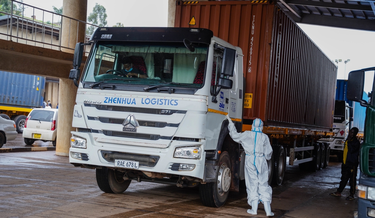 Health worker inspects a cross border truck at Rusumo One Stop Border Post, during the Covid 19 period. Craish Bahizi