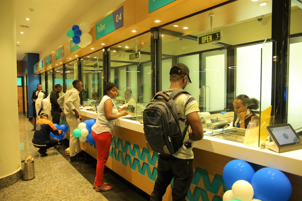 I&M Bank tellers attend to clients at the headquarters branch in Kigali City. Craish Bahizi