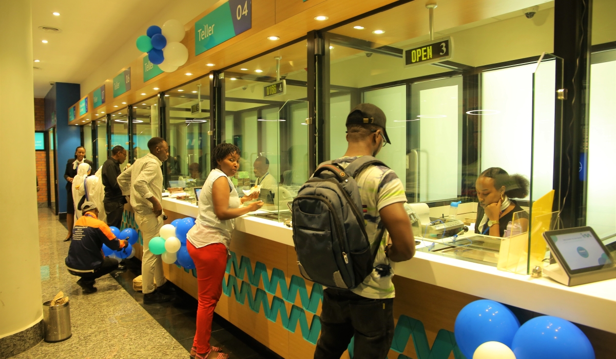 I&M Bank tellers attend to clients at the headquarters branch in Kigali City. Craish Bahizi