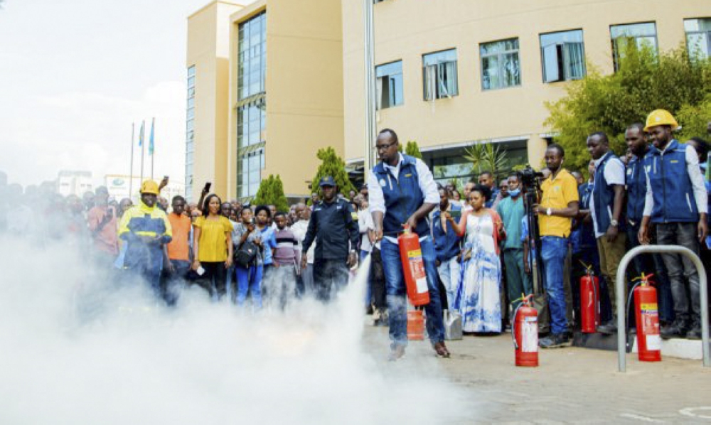 Rwanda National Police officers train City of Kigali workers who to fight against fire outbreak. File