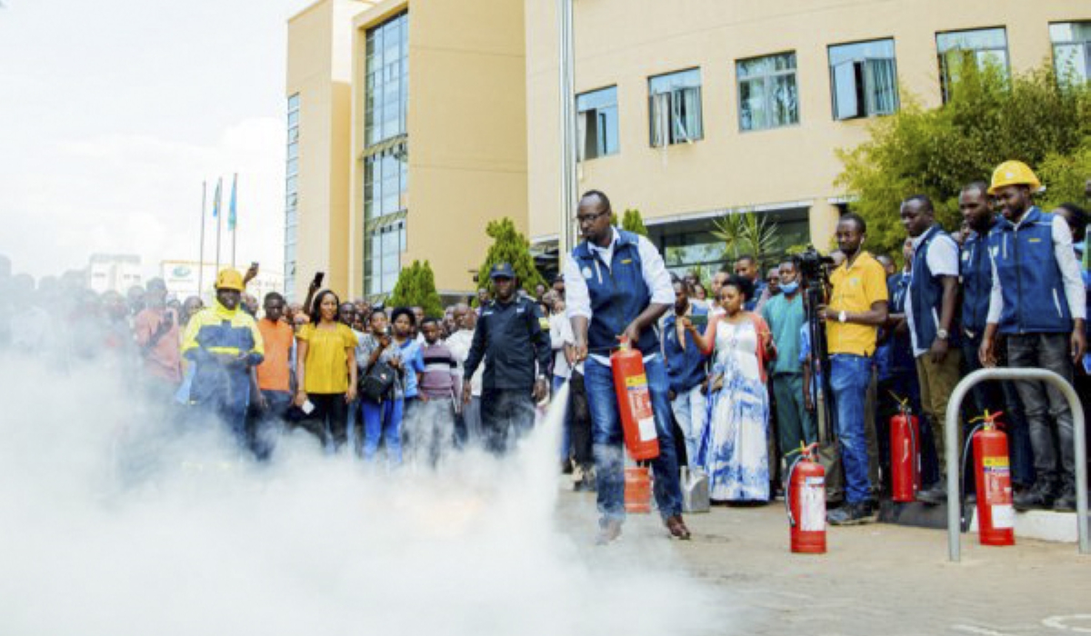 Rwanda National Police officers train City of Kigali workers who to fight against fire outbreak. File