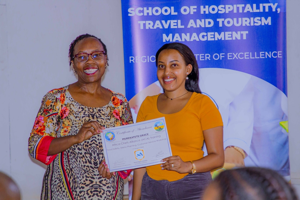 Dr Nelly Wamaitha hands over a certificate of attendance to Grace Murekatete for attending the Africa Chefs Alliance (ACA) training