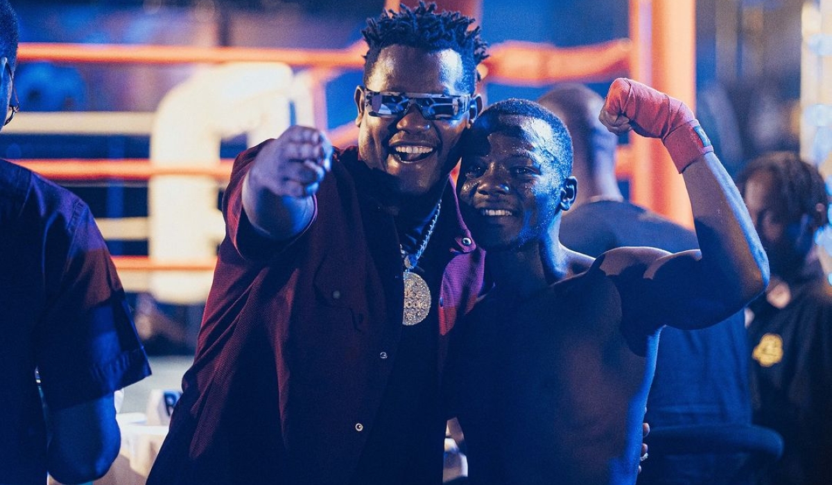 Singer Bruce Melodie shares a moment with a boxer at a previous Universe Boxing Championship event. The third edition returns this Sunday. COURTESY