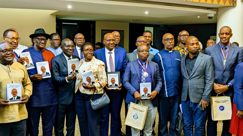 Distinguished figures, including members of the Rwanda Writers Federation, government officials, veteran politicians, and representatives from nearly all universities across Rwanda pose for a group photo after the book launch at the Intare Arena, the headquarters of the Rwanda Patriotic Front-Inkotanyi, on November 1. PHOTOS BY FRANK NTARINDWA