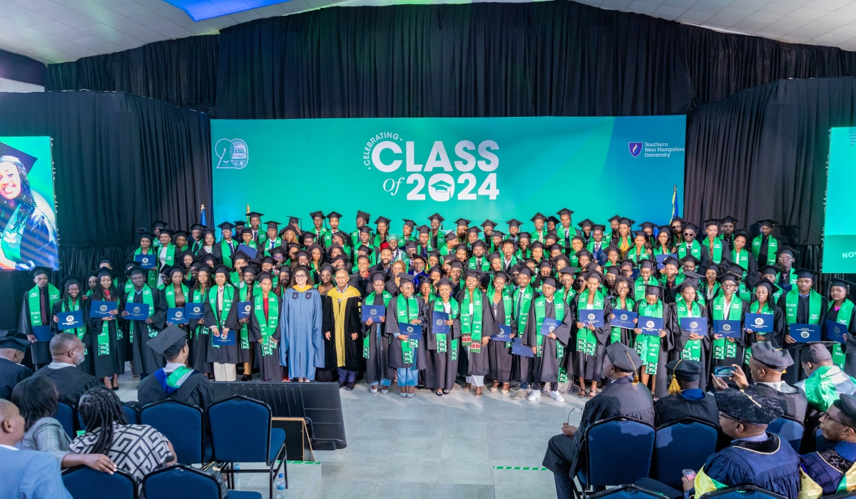 Graduates and officials pose for a group photo during the ceremony in Kigali on November 1,