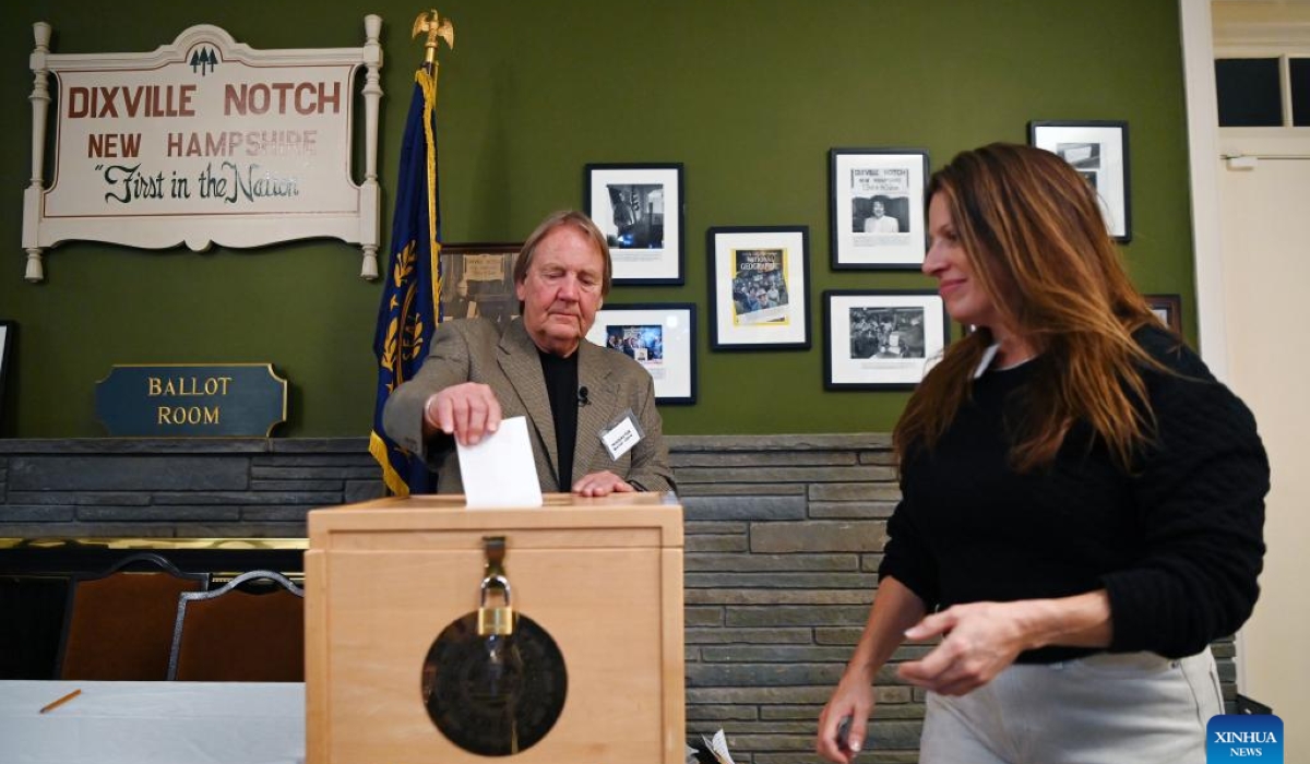 A moderator helps a voter (R) cast her ballot for the U.S. presidential election in Dixville Notch, New Hampshire, the United States, on Nov. 5, 2024. Voters in Dixville Notch, New Hampshire, went to the polls early Tuesday morning, marking the official start of Election Day voting for the 2024 U.S. presidential election. (Xinhua/Li Rui)