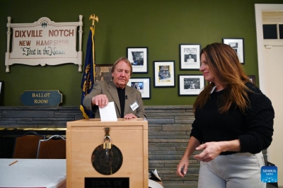 A moderator helps a voter (R) cast her ballot for the U.S. presidential election in Dixville Notch, New Hampshire, the United States, on Nov. 5, 2024. Voters in Dixville Notch, New Hampshire, went to the polls early Tuesday morning, marking the official start of Election Day voting for the 2024 U.S. presidential election. (Xinhua/Li Rui)