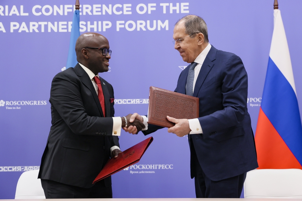 Rwanda&#039;s Minister of Foreign Affairs and International Cooperation, Olivier Nduhungirehe, and his Russian counterpart Sergey Lavrov,  shake hands after signing the visa waiver agreement for holders of service and 