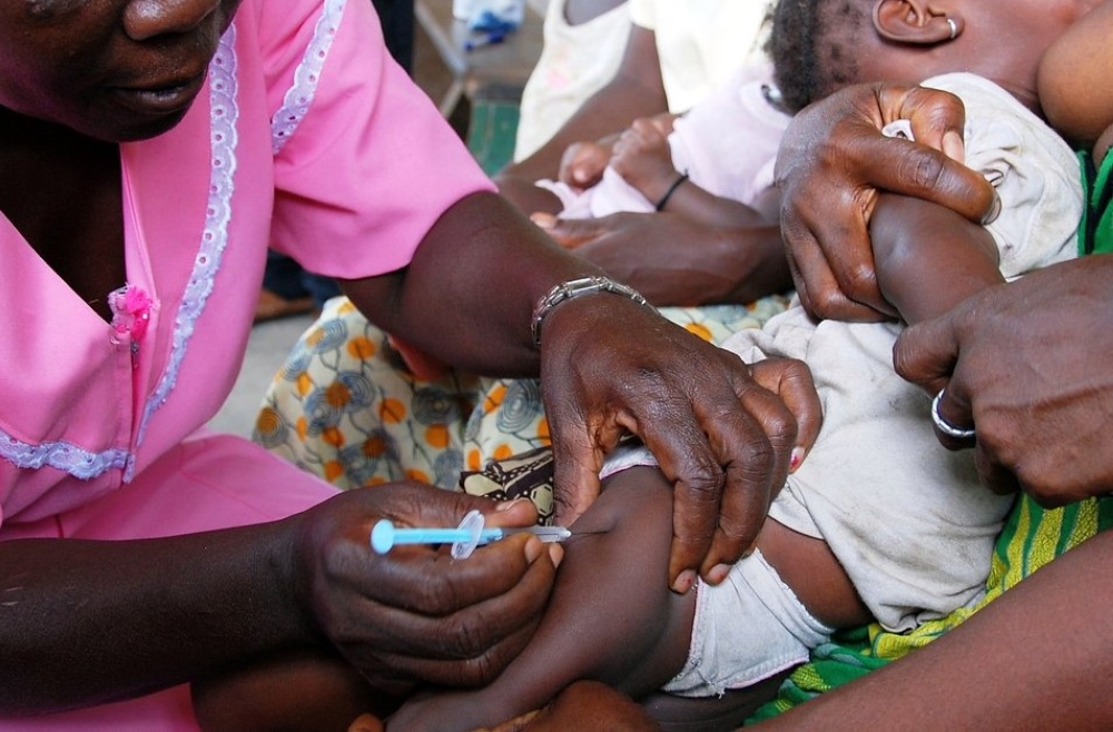 A healthcare worker administers a pneumococcal catch-up vaccine to a baby in the village of Kandaor, BO district, Sierra Leone, on June 13, 2011. The Rwanda Biomedical Center (RBC) reported that this condition accounted for 16% of consultations across all health centers. Photo courtesy