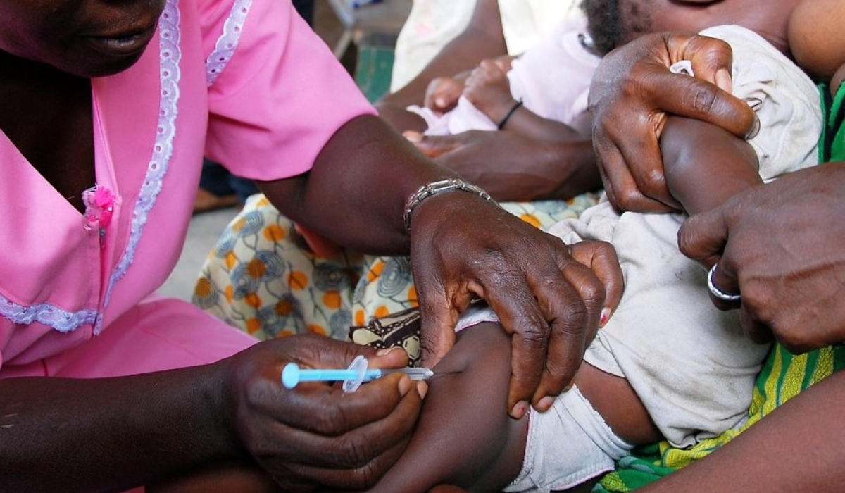 A healthcare worker administers a pneumococcal catch-up vaccine to a baby in the village of Kandaor, BO district, Sierra Leone, on June 13, 2011. The Rwanda Biomedical Center (RBC) reported that this condition accounted for 16% of consultations across all health centers. Photo courtesy