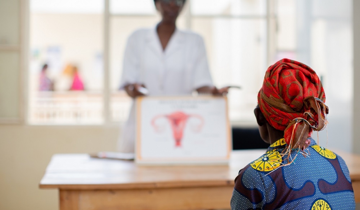 A nurse uses a poster to explain cervical cancer to a patient in Rwanda. It is a serious disease that poses a significant threat to women’s health worldwide. Photo Courtesy