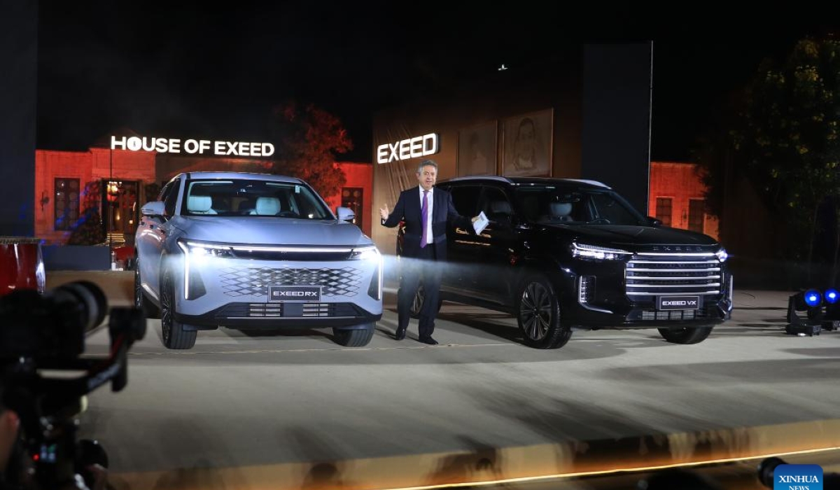 A man introduces two Exeed SUV models at a launching ceremony in northern Great Cairo, Egypt, on Nov. 18, 2024. Chinese premium automotive brand Exeed, a subsidiary of automaker Chery, has introduced two SUV models, the Exeed RX and Exeed VX, to the Egyptian market. (Xinhua/Sui Xiankai)