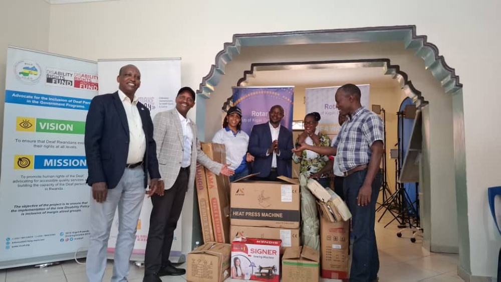 Officials from Rotary Club of Kigali Golf (RCKG) hand over tailoring machines and knitting equipment to Nyereka Ibiganza Byawe, in Huye, on Friday, November 22. Photos by Alice Umutesi