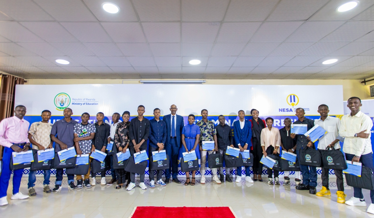 Officials pose for a group photo with best performers of 2023-2024 national examinations. Courtesy