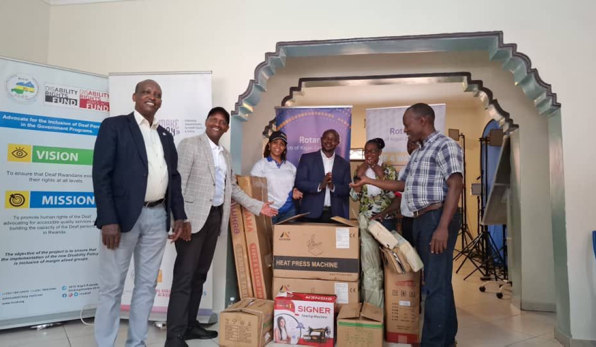 Officials from Rotary Club of Kigali Golf (RCKG) hand over tailoring machines and knitting equipment to Nyereka Ibiganza Byawe, in Huye, on Friday, November 22. Photos by Alice Umutesi