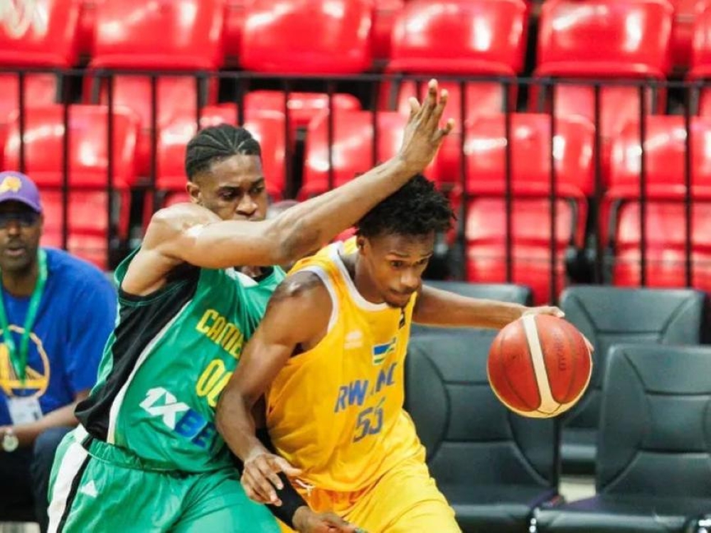 Osborn Shema dribbles under pressure from a Cameroonian opponent during Saturday night&#039;s loss-courtesy