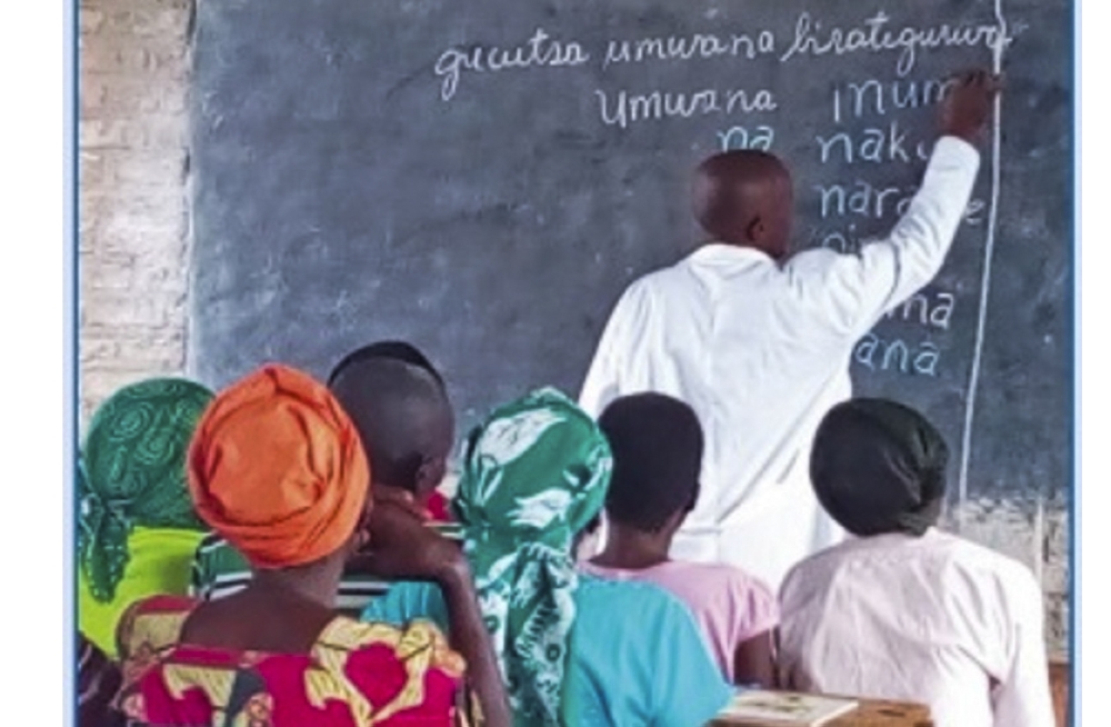 A teacher during a class of adults during a reading session. Rwanda aims to train 710,852 illiterate adults, equipping them with basic reading, counting and writing skills by 2029. File