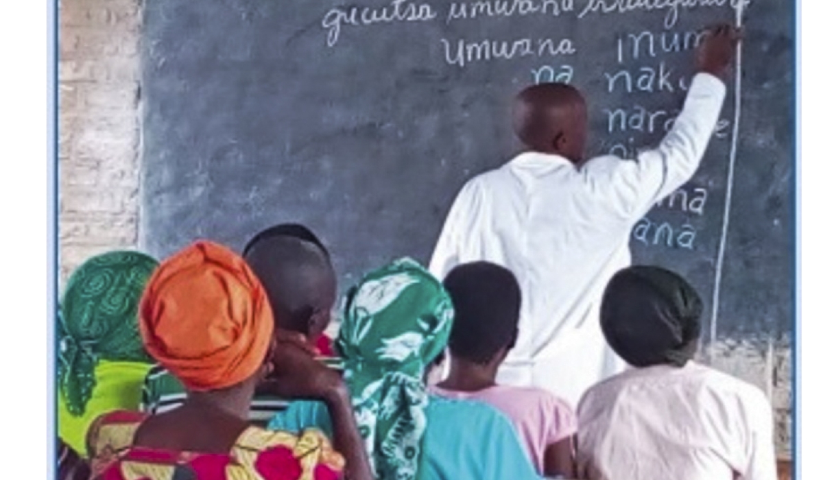 A teacher during a class of adults during a reading session. Rwanda aims to train 710,852 illiterate adults, equipping them with basic reading, counting and writing skills by 2029. File