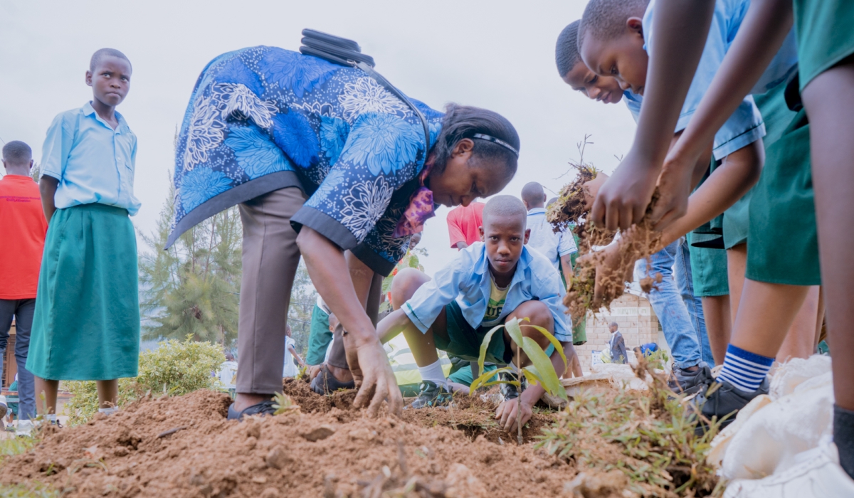 EP Kagina’s Director of Studies, Denyse Uwizeye, demonstrates tree planting to students while commending Mount Kigali University for the initiative.