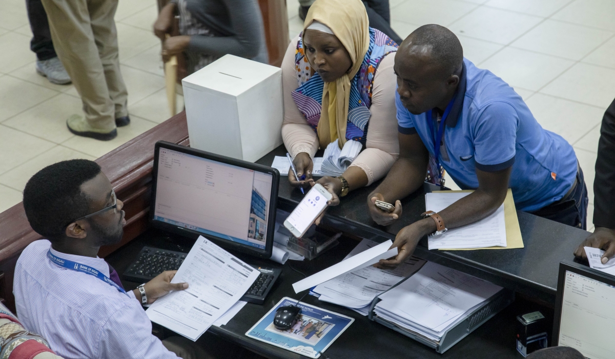 Bank of Kigali customers interact with the staff at the bank&#039;s main branch in Kigali. Photo by Sam Ngendahimana