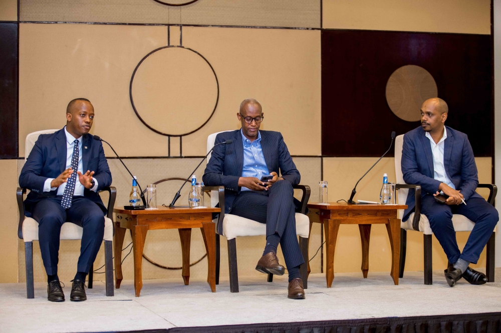 RSSB CEO Regis Rugemanshuro (L) addresses private sector representatives during a financial inclusion forum organized by the Private Sector Federation as Stephen Ruzibiza PSF CEO looks on