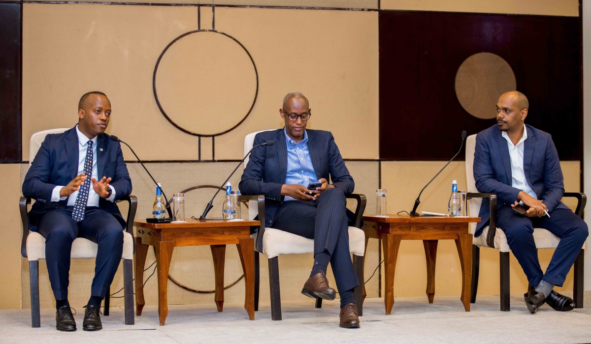 RSSB CEO Regis Rugemanshuro (L) addresses private sector representatives during a financial inclusion forum organized by the Private Sector Federation as Stephen Ruzibiza PSF CEO looks on