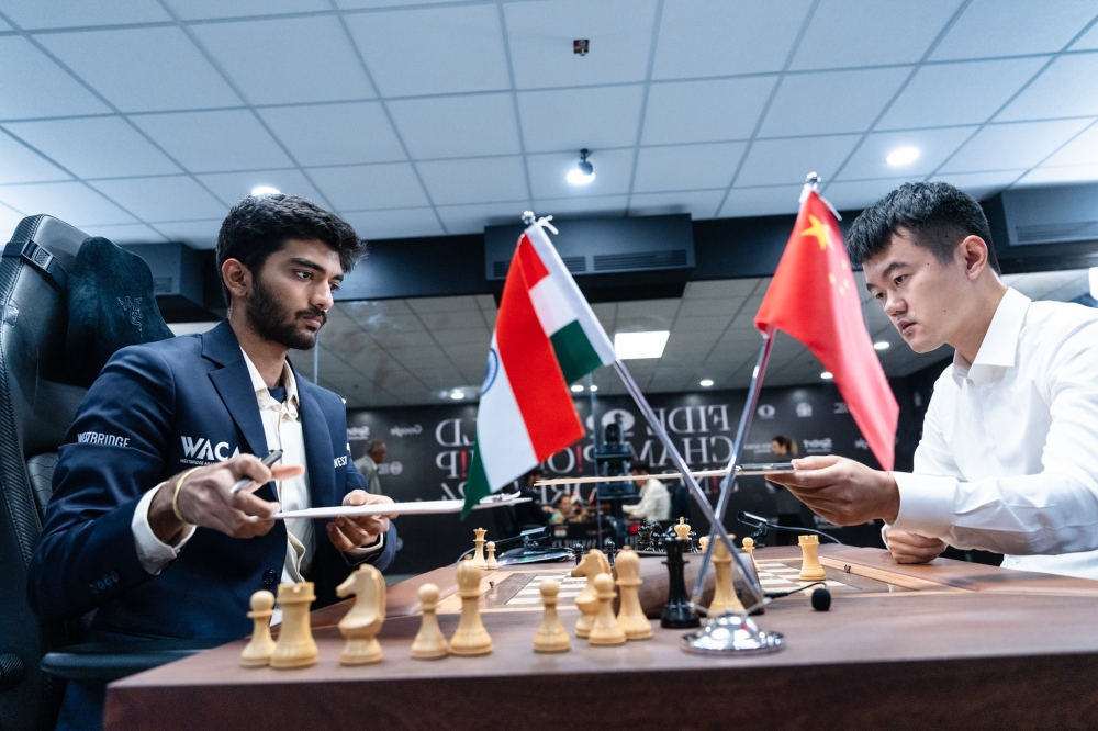 India’s GM Gukesh Dommaraju and China&#039;s GM Ding Liren exchange score sheets after Game 4 in the 2024 FIDE World Championship Match in Singapore ended in a 42-move draw after threefold repetition on Friday, November 29. Courtesy of FIDE