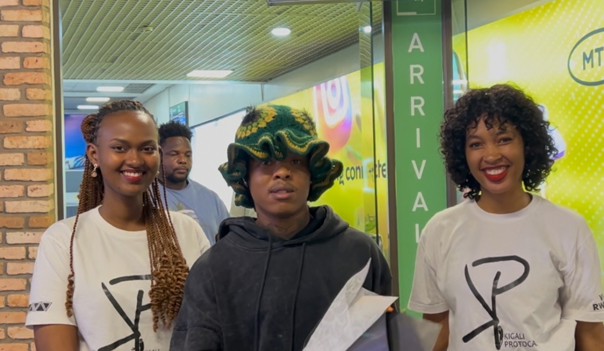 South African rapper Nasty C takes a photo with two young women from Kigali Protocol upon arrival at Kigali International Airport on Thursday night ahead of his performance at Davis D&#039;s Shineboy Fest-courtesy