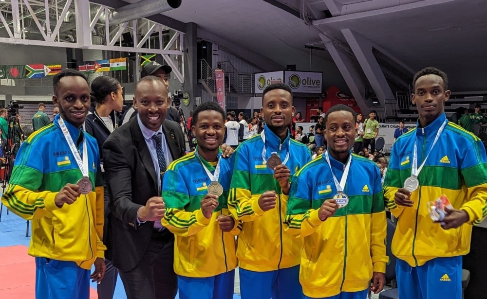 L-R: Fiston Ntwali, Damien Niyongabo, the president of Rwanda Karate Federation, Sidike Niyonkuru, Harifa Niyitanga, Sharifu Dushime, and Maïc Ndutiye Shyaka pose for a picture after a medal awarding ceremony at the 11th Commonwealth Karate Championships 2024, in Durban, South Africa, on Friday, November 29. Courtesy of FERWAKA