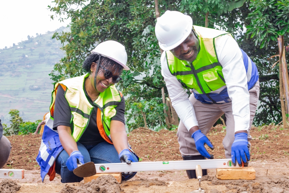 Pauline Okumu, National Director of World Vision Rwanda and Maurice Mugabowagahunde, Governor of the Northern Province lay a foundation stone for ECD center and a second-generation health post in Buzaniro, in Burera District on Thursday. Photos by Fidele Nsengiyumva