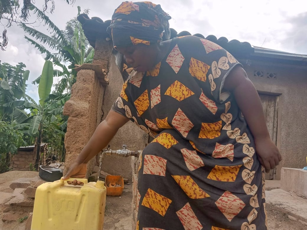 Afisa Muhawenimana fetches water from a newly installed station  in Nyamugari sector in Kirehe.  Muhawenimana lost her eldest son in 2022 when drowned in the Akagera River after he went to fetch water.