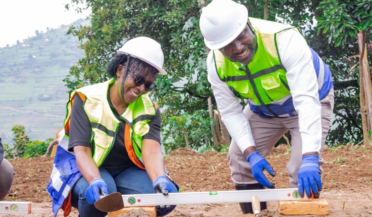 Pauline Okumu, National Director of World Vision Rwanda and Maurice Mugabowagahunde, Governor of the Northern Province lay a foundation stone for ECD center and a second-generation health post in Buzaniro, in Burera District on Thursday. Photos by Fidele Nsengiyumva