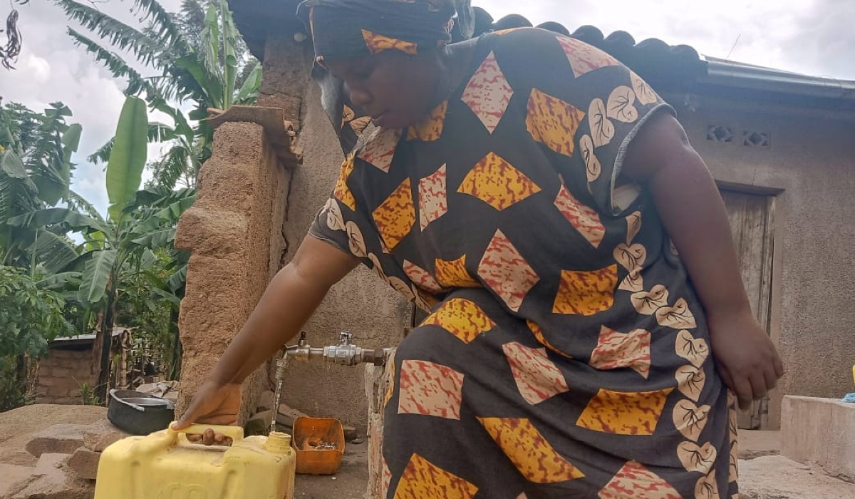 Afisa Muhawenimana fetches water from a newly installed station  in Nyamugari sector in Kirehe.  Muhawenimana lost her eldest son in 2022 when drowned in the Akagera River after he went to fetch water.