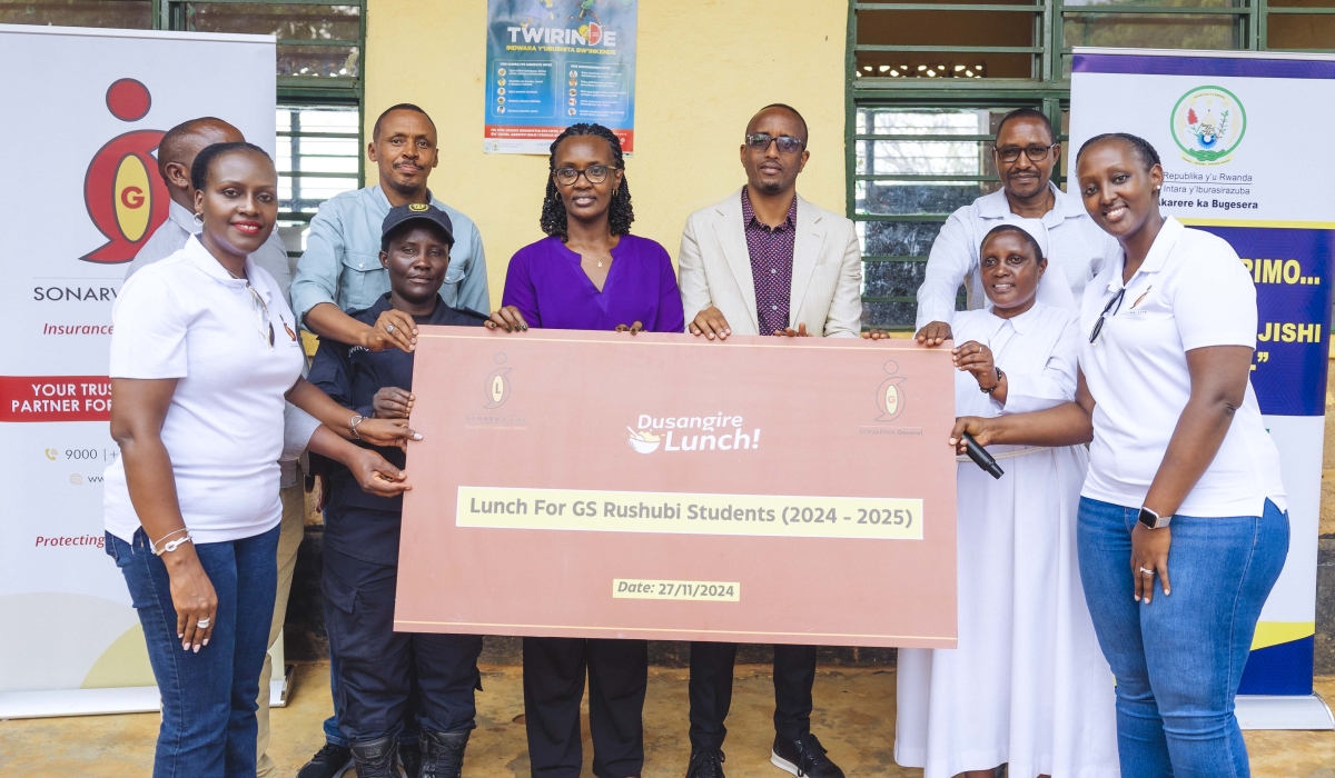 SONARWA Life Assurance Company Ltd and SONARWA General Insurance Company Ltd officials hand over a cheque to school officials at Groupe Scolaire Rushubi Catholique in Bugesera District. Courtesy