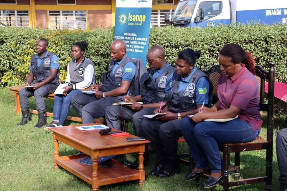 Rwanda Investigation Bureau personnel and local officials engage with residents in Gakenke District during a meeting to raise awareness about gender-based violence. (PhotoCourtesy).