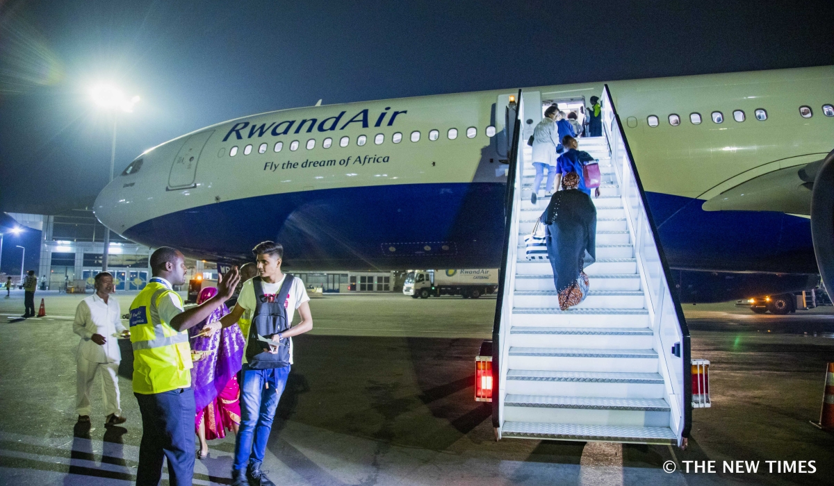 Passengers board a RwandAir plane at Kigali International Airport. Starting from Thursday, December 5, travelers from Rwanda will no longer be redirected to three designated U.S. airports.