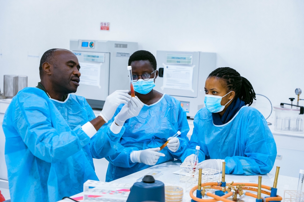 Lab technicians examine a sample. Photo by Craish Bahizi