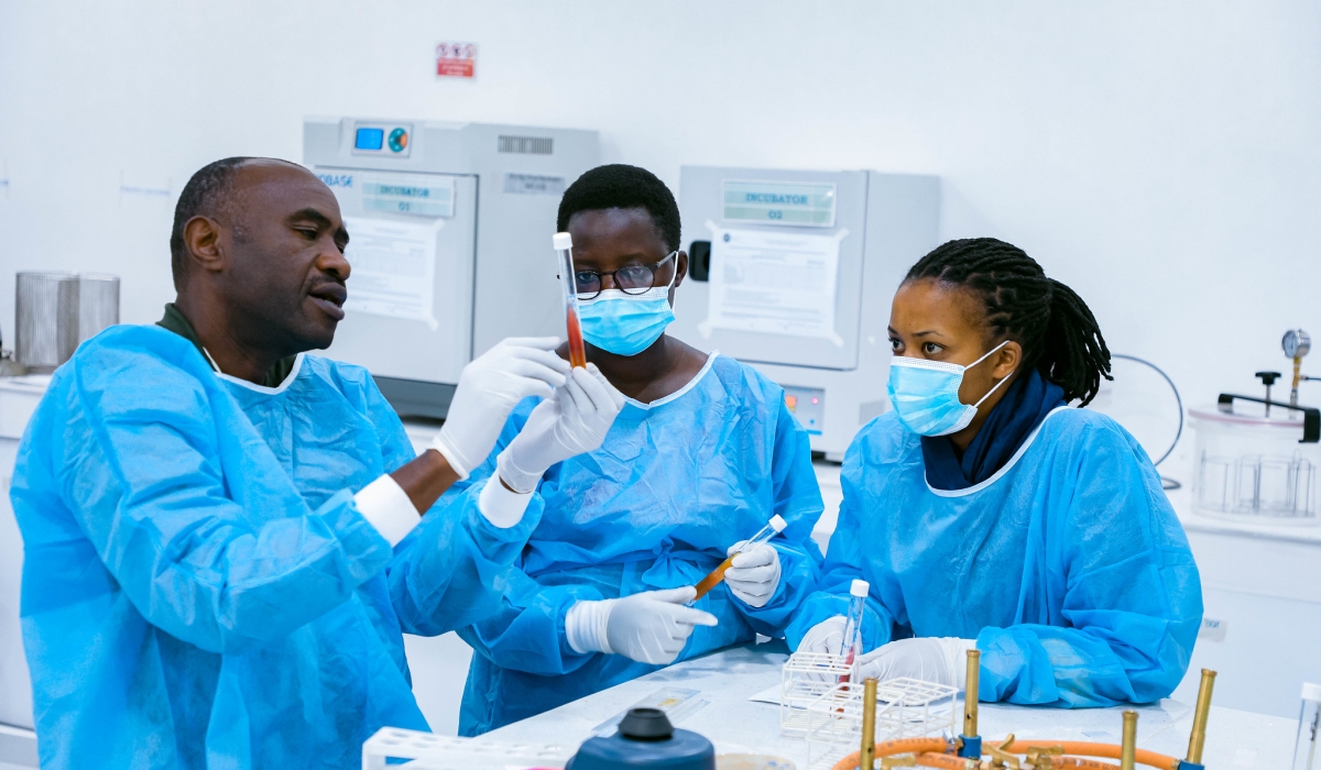 Lab technicians examine a sample. Photo by Craish Bahizi