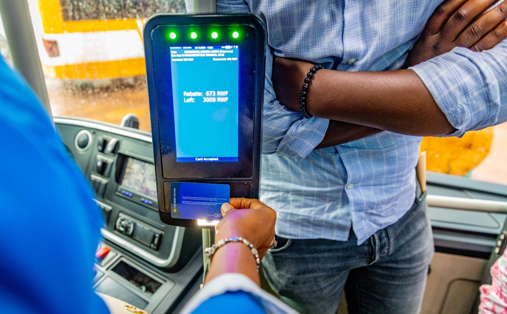 Commuters board a public bus during the launch of the distance-based fare system in Kigali on Wednesday, December 4.  photos by Craish Bahizi