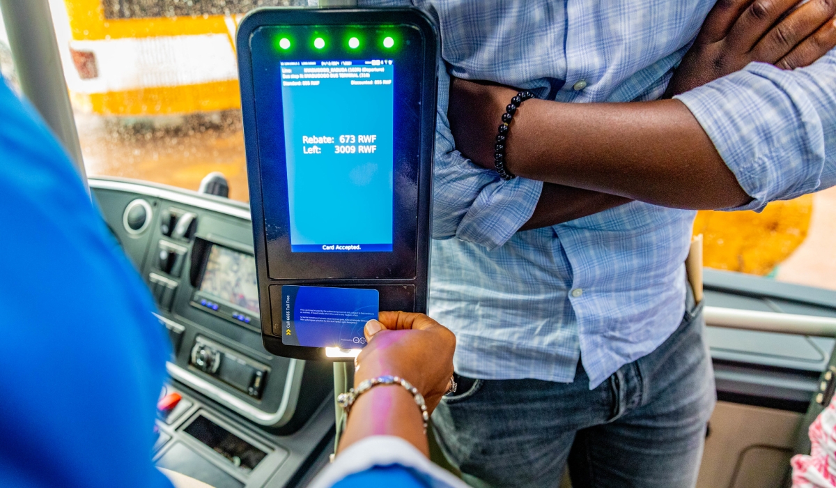 Commuters board a public bus during the launch of the distance-based fare system in Kigali on Wednesday, December 4.  photos by Craish Bahizi