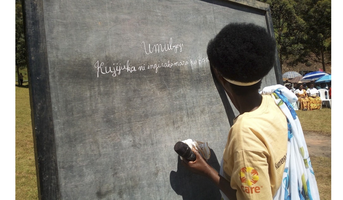 Venantie Mukamutara, one of the residents who completed literacy training for adults, showcases her writing skills during a graduation ceremony in Gisagara District in August 2024. Courtesy