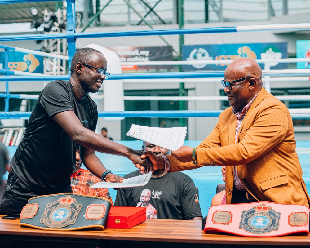 WABA president Onesmo Alfred McBride exchanges documents with WABA Rwanda&#039;s Guy Rurangayire after approving Rwanda as new member of WABA-courtesy