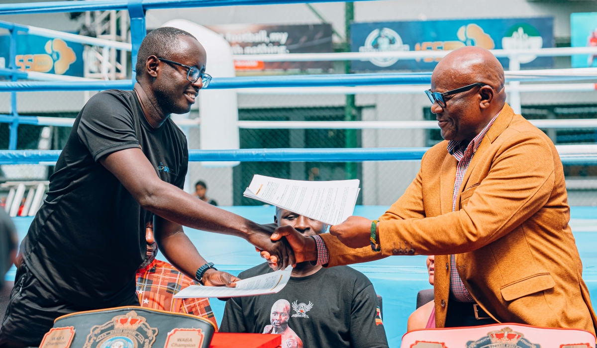 WABA president Onesmo Alfred McBride exchanges documents with WABA Rwanda&#039;s Guy Rurangayire after approving Rwanda as new member of WABA-courtesy