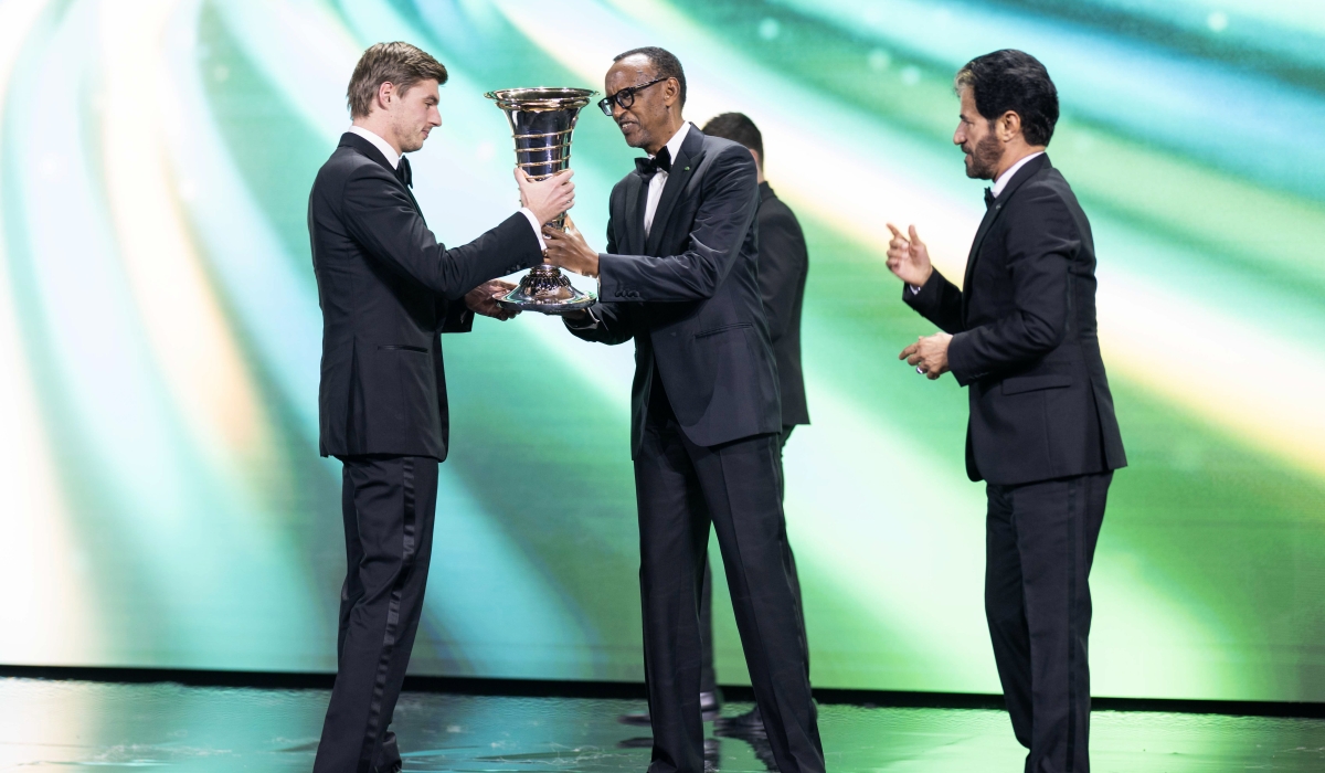 Formula One 2024 champion and Red Bull star Max Verstappen (L) receives a trophy from President Paul Kagame (C) at the FIA Awards ceremony held at BK Arena in Kigali on Friday, December 13-Village Urugwiro