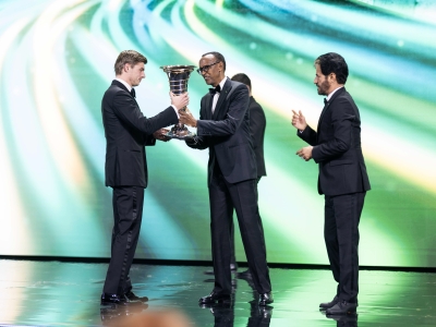 Formula One 2024 champion and Red Bull star Max Verstappen (L) receives a trophy from President Paul Kagame (C) at the FIA Awards ceremony held at BK Arena in Kigali on Friday, December 13-Village Urugwiro