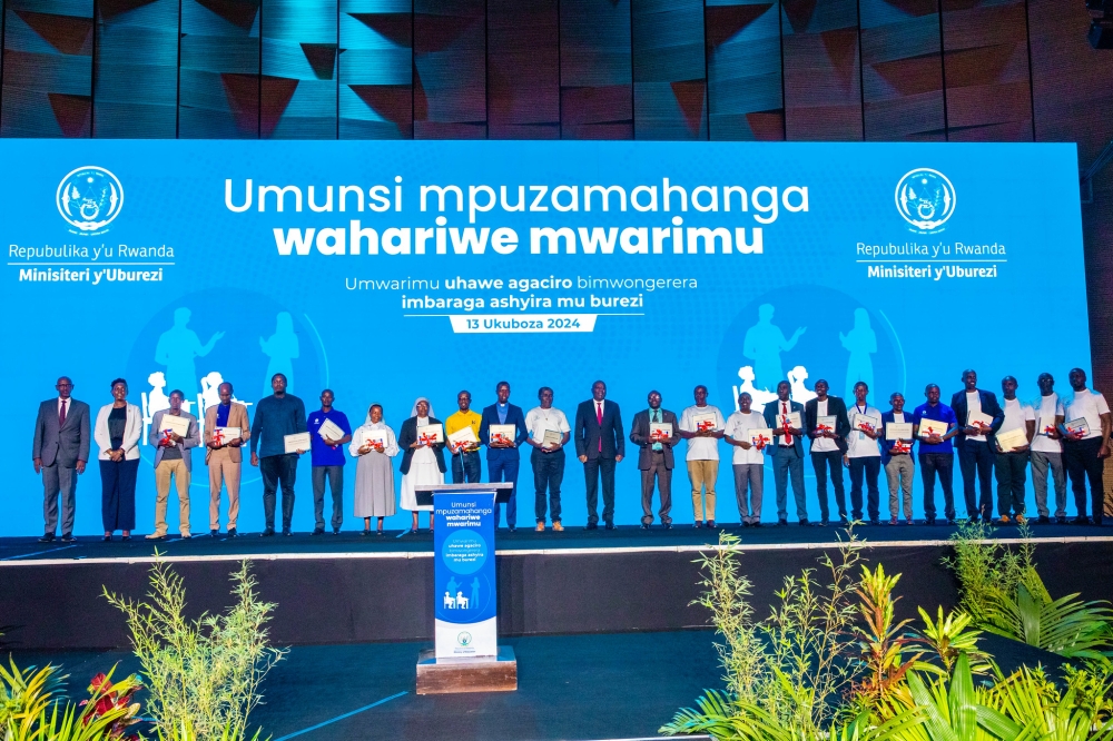 Prime Minister Ngirente poses for a photo with the best-performing teachers who were awarded at the ceremony on Friday, December 13. Photo by Craish Bahizi