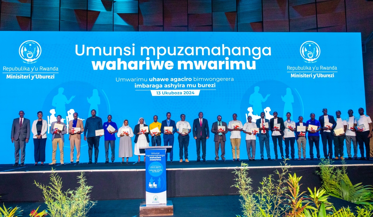 Prime Minister Ngirente poses for a photo with the best-performing teachers who were awarded at the ceremony on Friday, December 13. Photo by Craish Bahizi