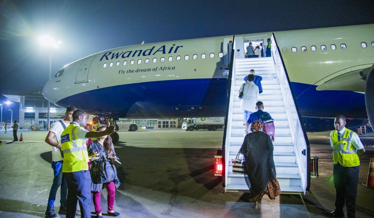 Travellers board RwandAir plane at Kigali International Airport. File